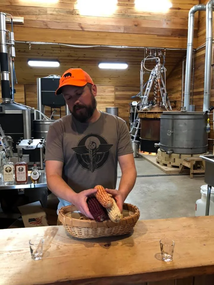 A distiller preparing corn inside Still Hollow Spirits in West Virginia.